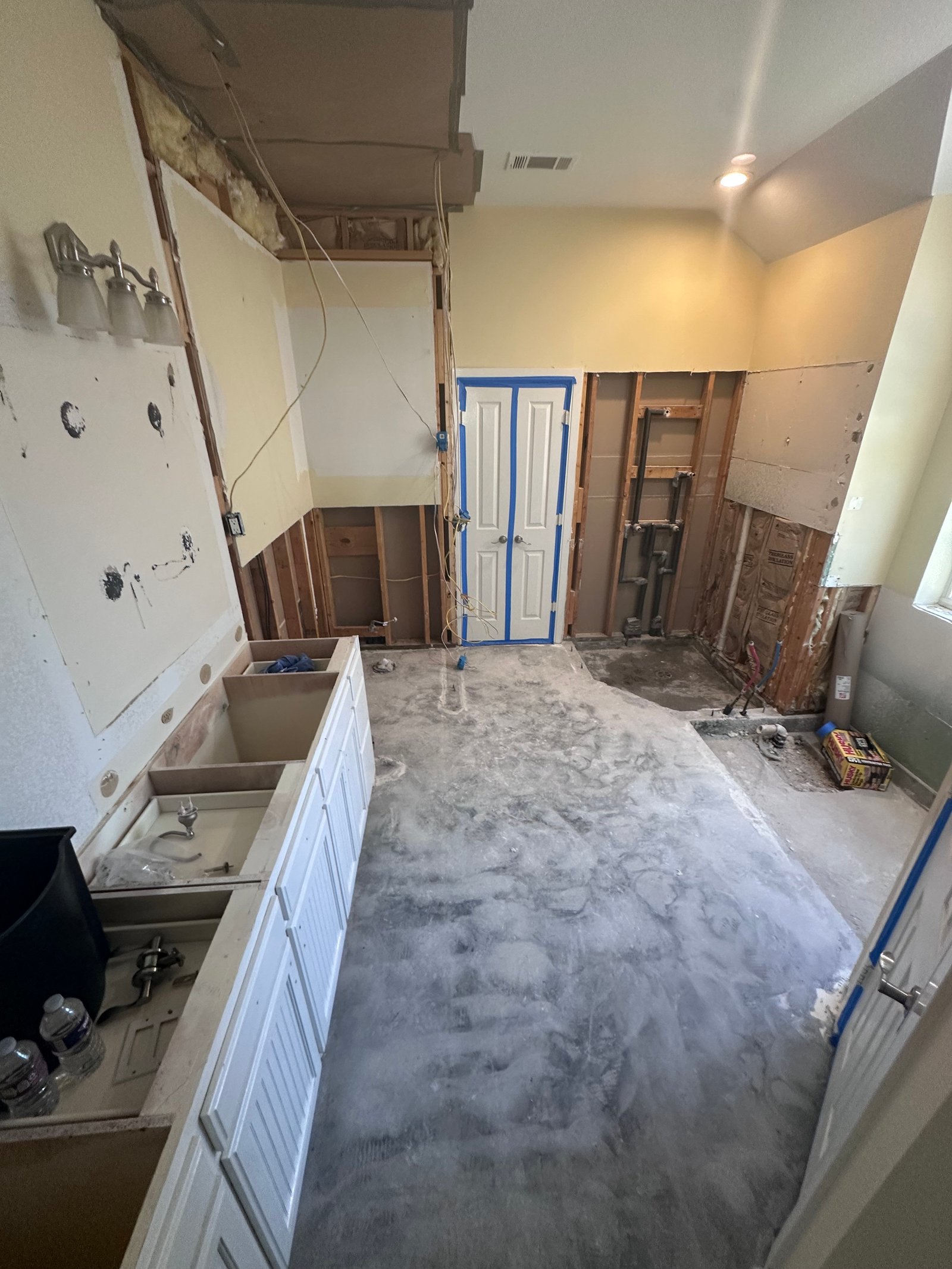 Bathroom and closet floor removed down to the bare concrete slab