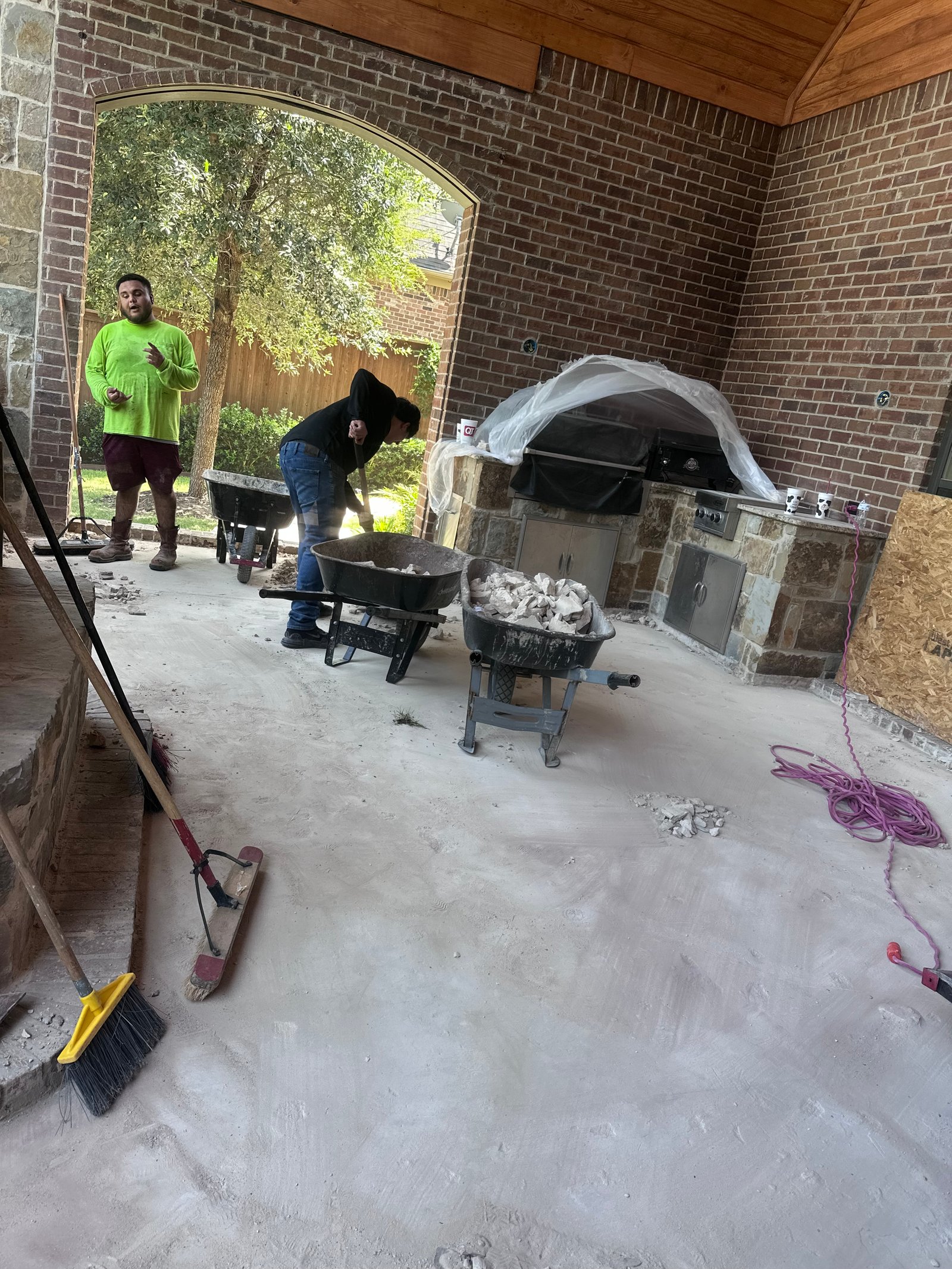 Crew clearing a covered patio and outdoor kitchen, JS Company LLC job