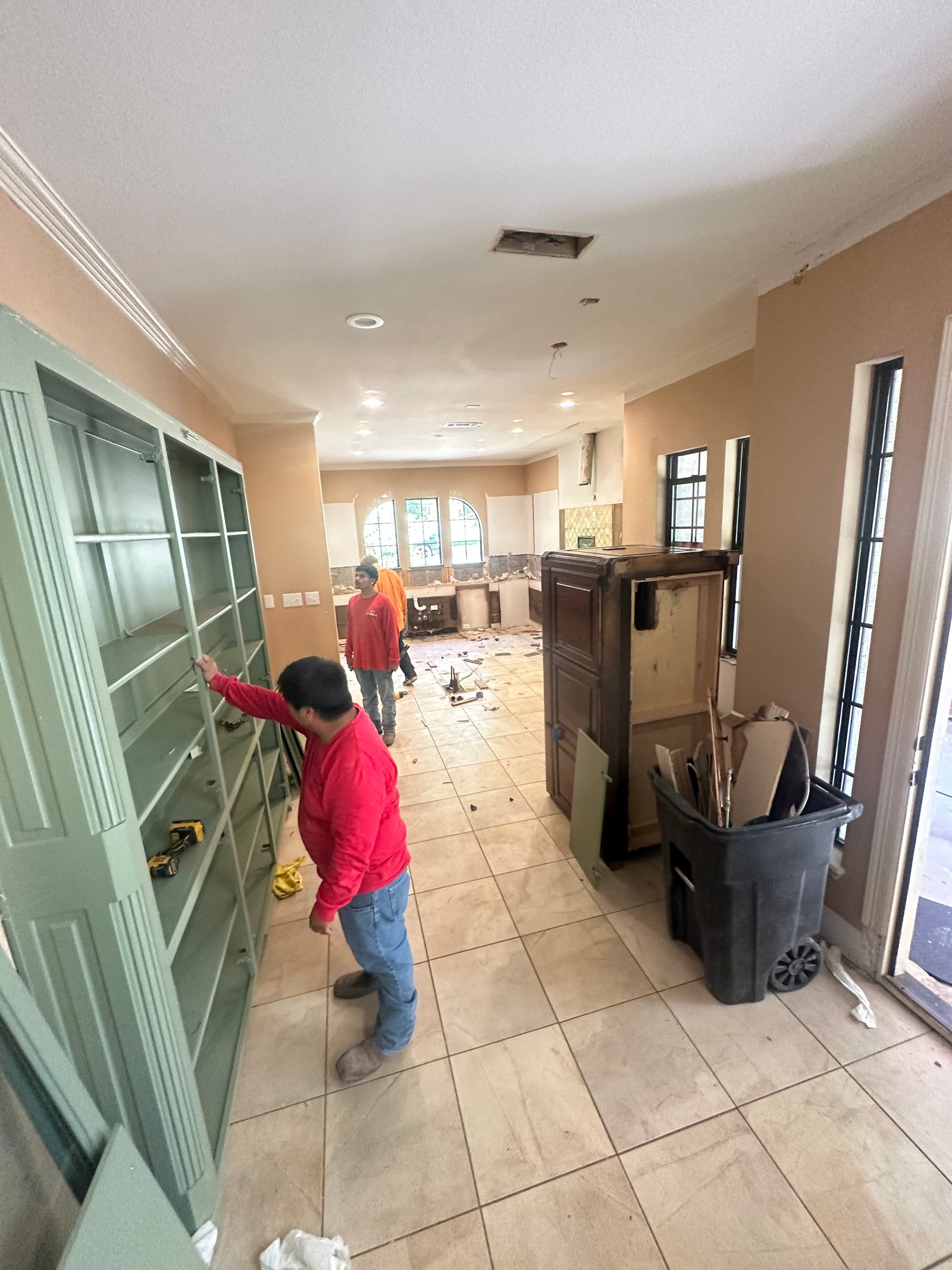 JS Company crew removing tile floors with the cabinets protected