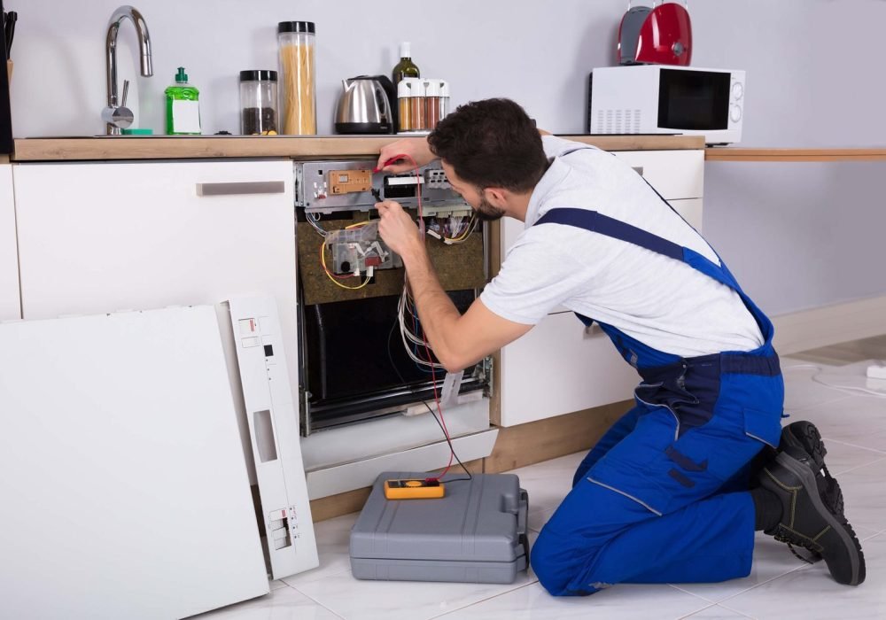 workman-fixing-a-dishwasher-scaled-1.jpg